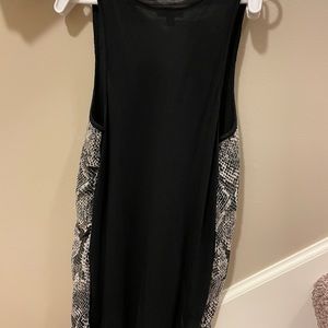 Has some sparkle. Black faux snake skin tank